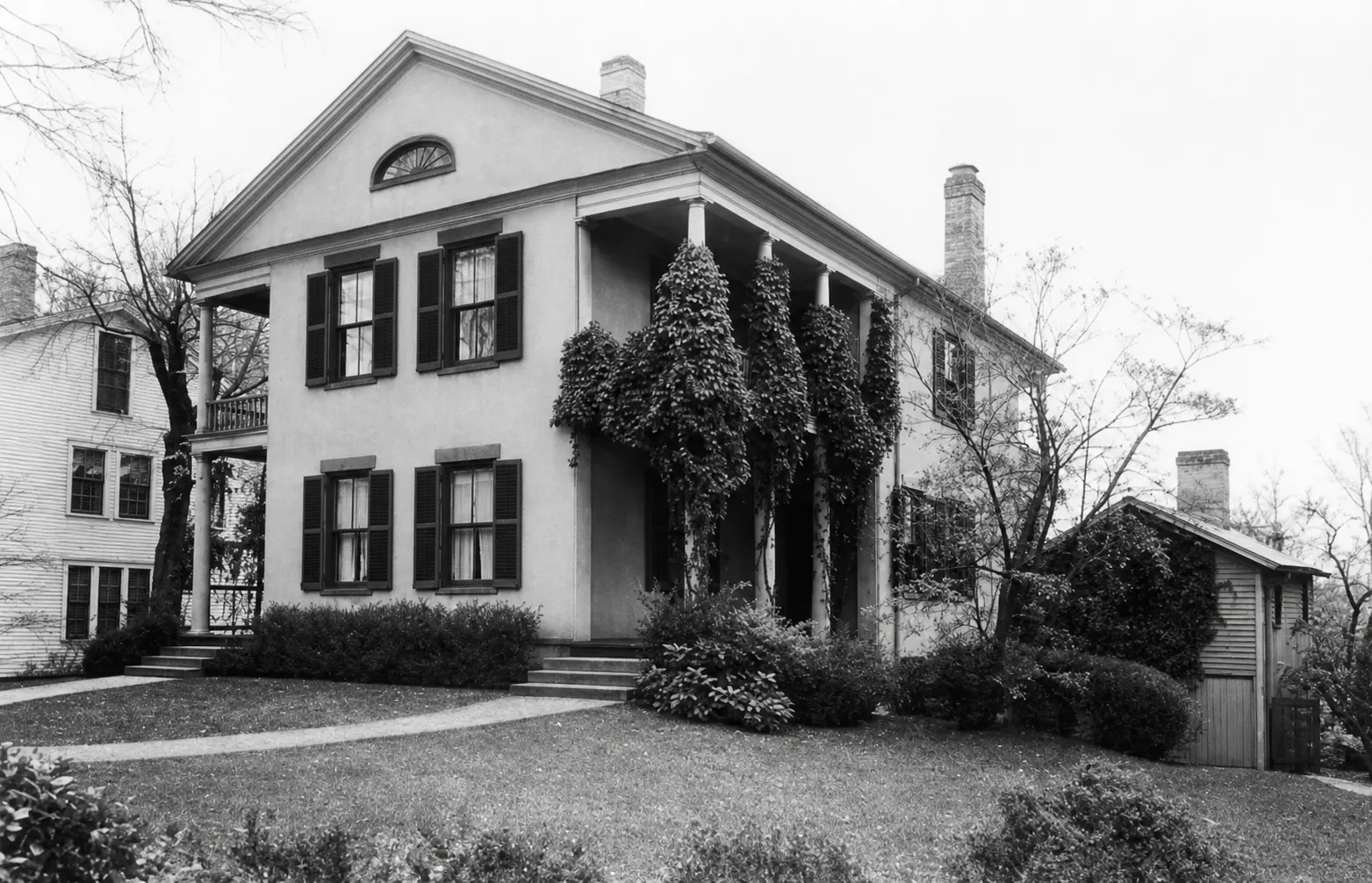 Restored archival photograph showing the front and side porches of the House of Seven Porches