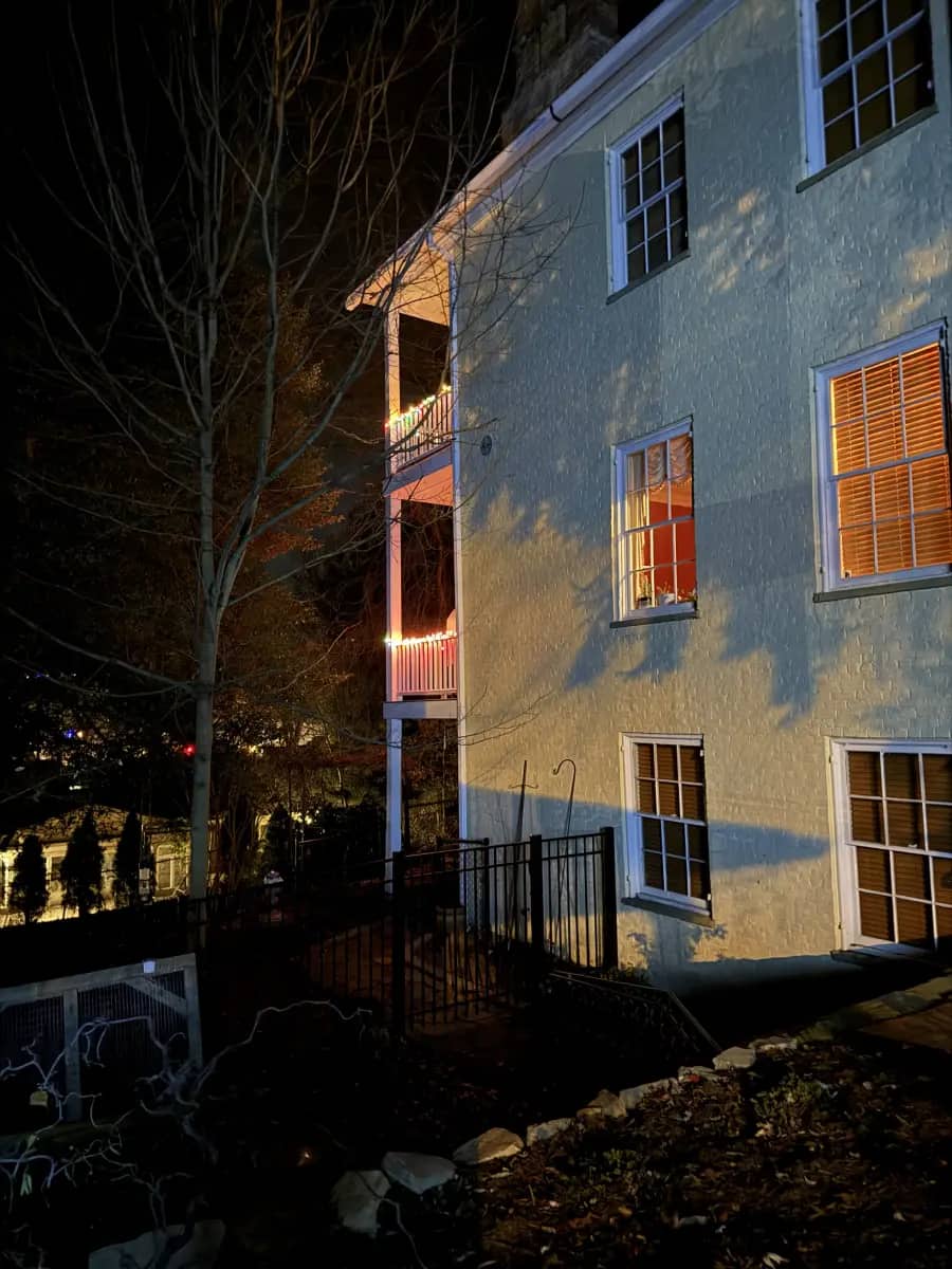 Night view of a side elevation with all three porch levels visible in profile